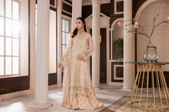 Woman in beige embroidered formal dress at LA ELISE, elegant indoor setting with columns