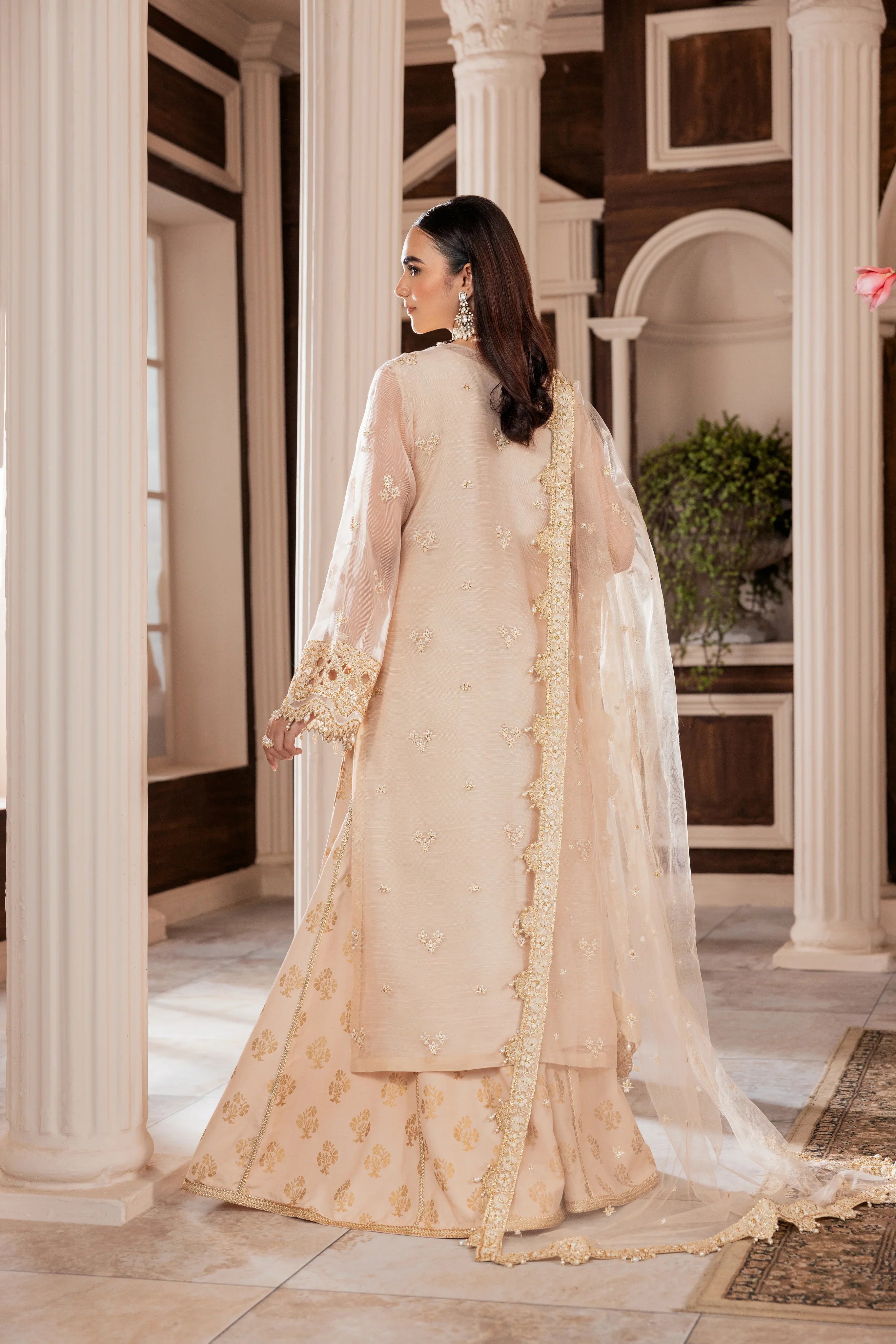 Woman in elegant beige embroidered formal dress with dupatta at LA ELISE, classic setting