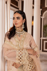 Woman in elegant beige embroidered formal dress with statement jewelry, LA ELISE fashion