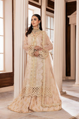 Woman in elegant gold embroidered formal dress at LA ELISE, luxury fashion setting