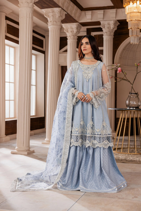 Woman in a light blue embellished formal dress with dupatta, standing in an elegant hall at LA ELISE.