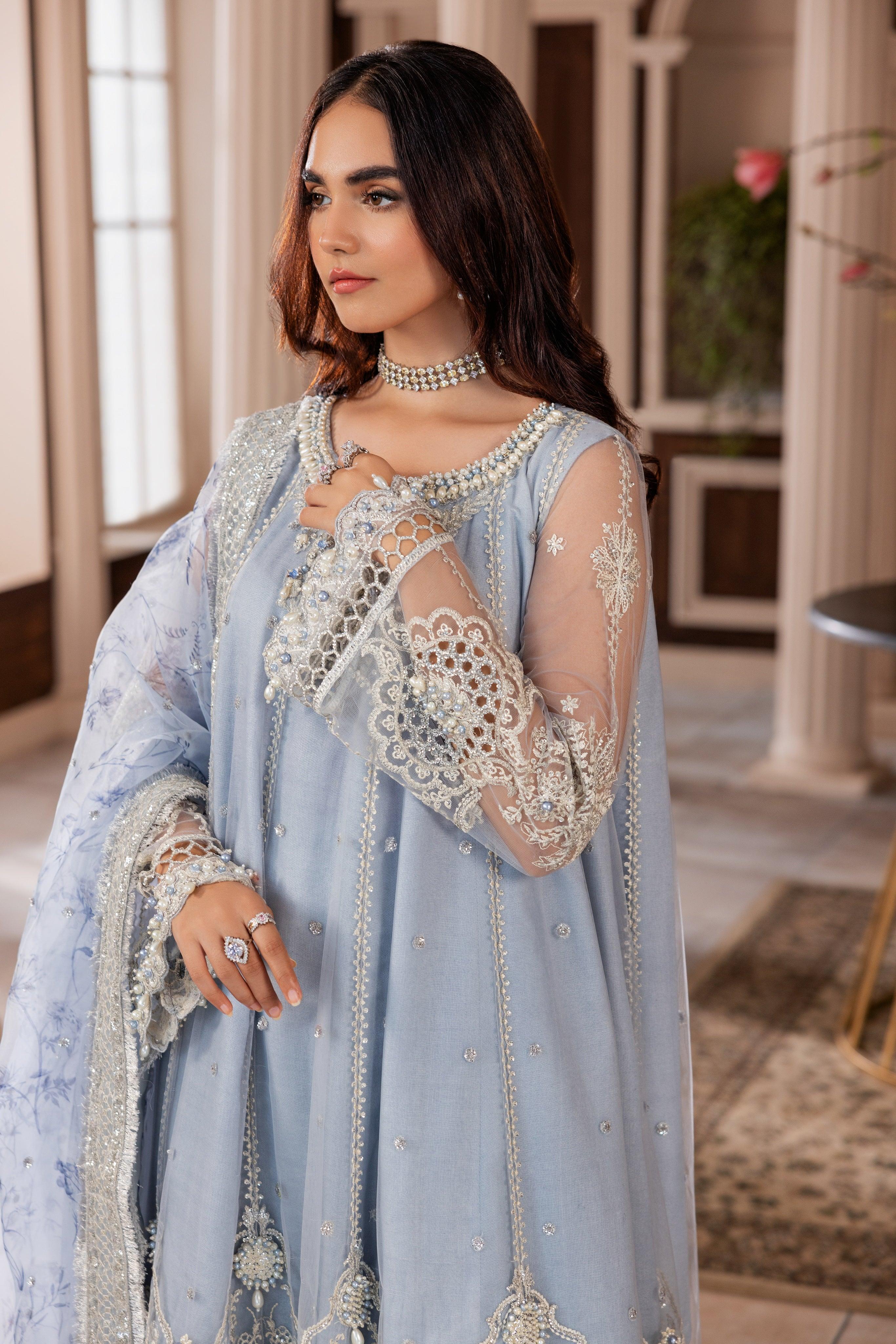 Woman in light blue embroidered formal dress from LA ELISE, styled with pearl jewelry