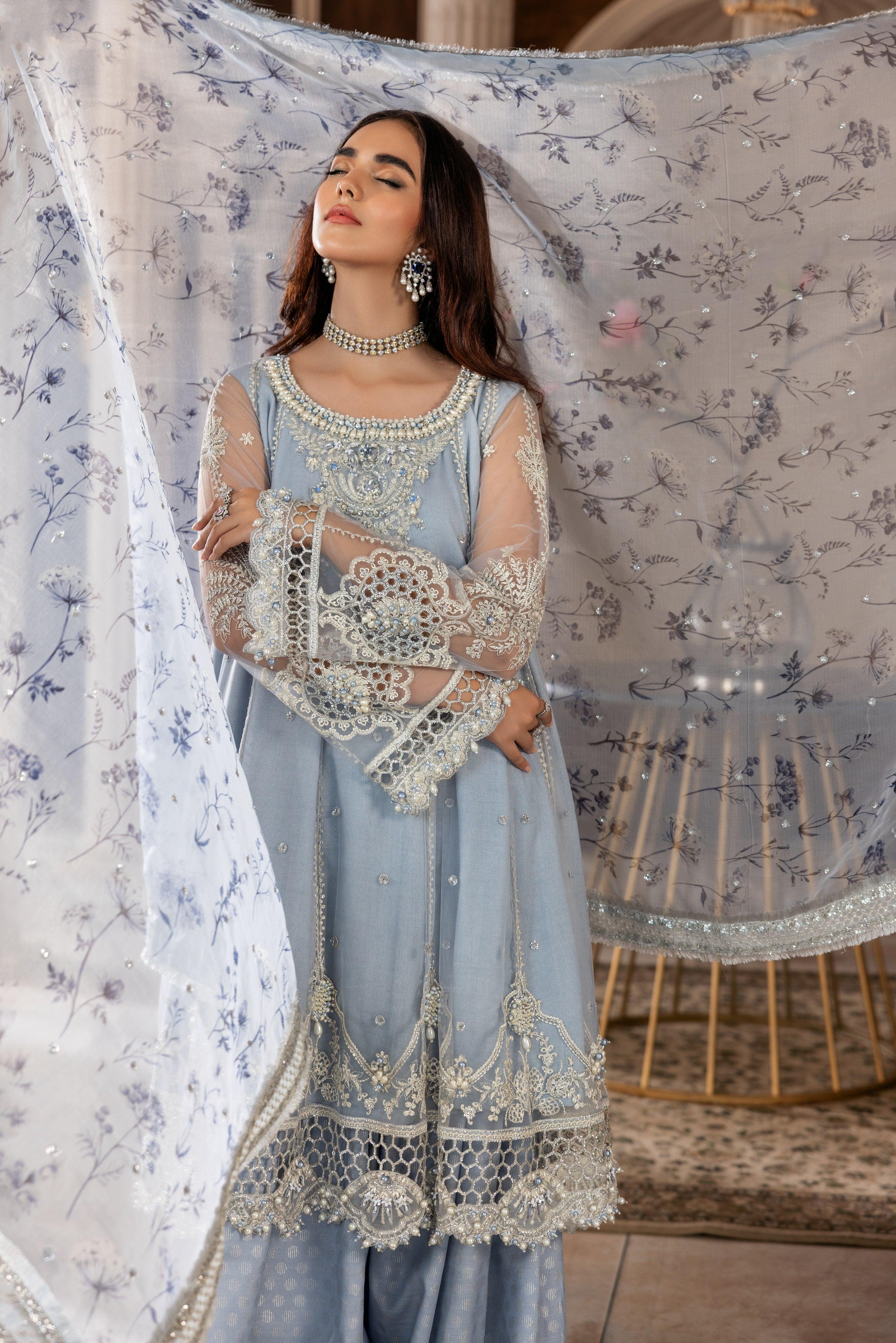Woman wearing light blue embroidered unstitched formal dress from LA ELISE collection
