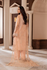 Woman in peach embroidered unstitched suit by LA ELISE, styled in elegant indoor setting