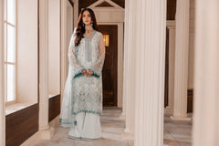 Woman modeling pastel embroidered formal suit from LA ELISE in elegant hallway