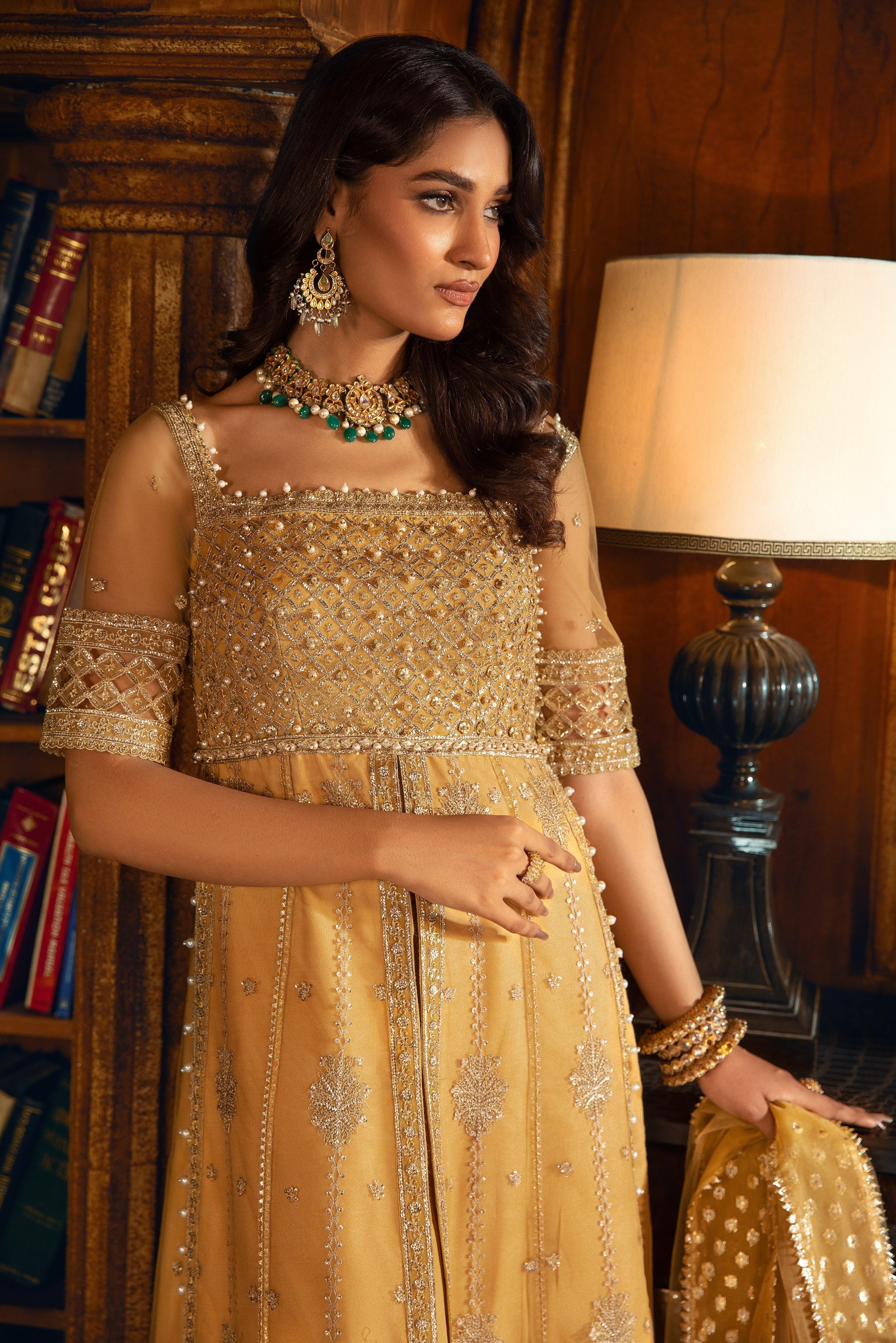 Woman in gold embroidered formal dress with jewelry, LA ELISE women’s fashion