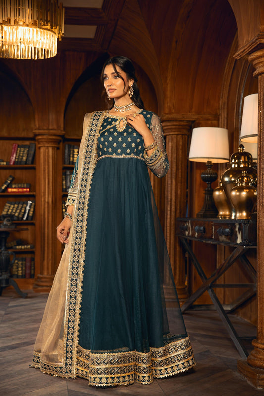 Elegant woman in dark green embellished formal dress from LA ELISE, standing in a luxurious library.