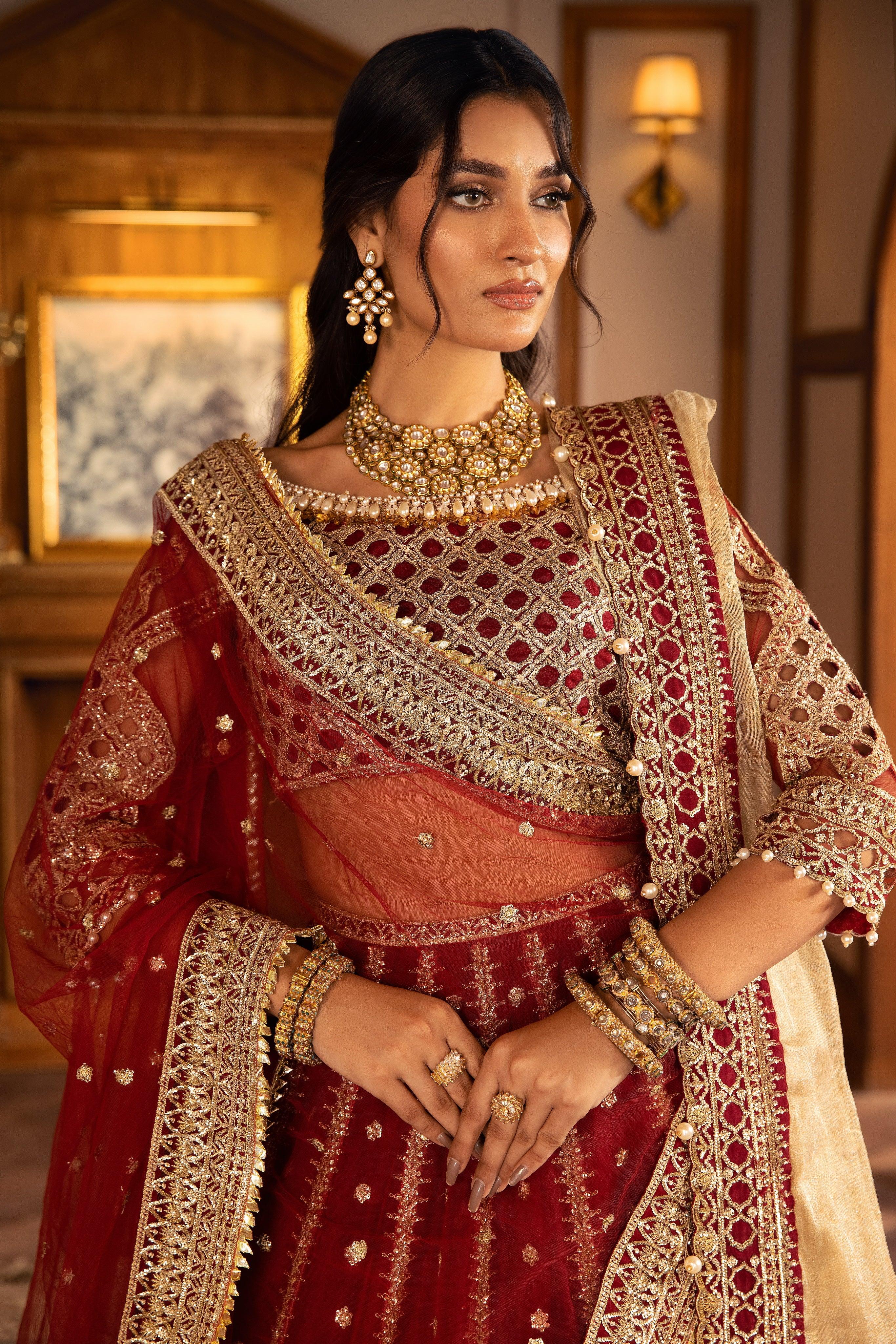 Woman in maroon and gold embellished formal dress, traditional jewelry, LA ELISE fashion