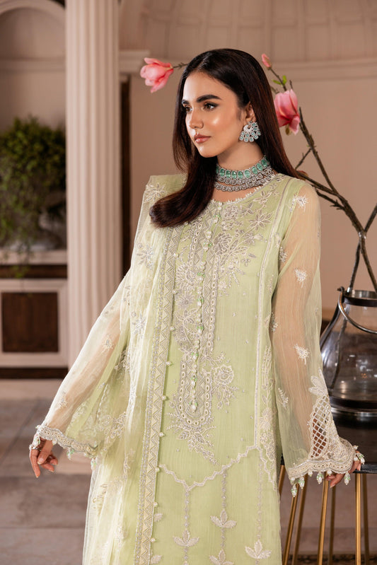Woman in pastel green embroidered formal dress from LA ELISE, elegant indoor setting