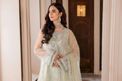 Woman modeling elegant pastel embroidered formal dress with jewelry at LA ELISE