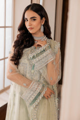 Woman in elegant pastel embroidered formal dress from LA ELISE, standing indoors