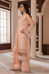 Woman in peach embroidered unstitched suit from LA ELISE, elegant indoor setting