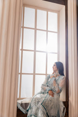 Woman in elegant unstitched embroidered dress sitting by window, LA ELISE women’s fashion