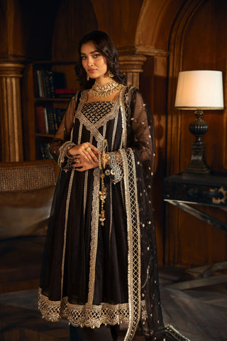 Woman in black and gold embroidered formal dress from LA ELISE, elegant indoor setting