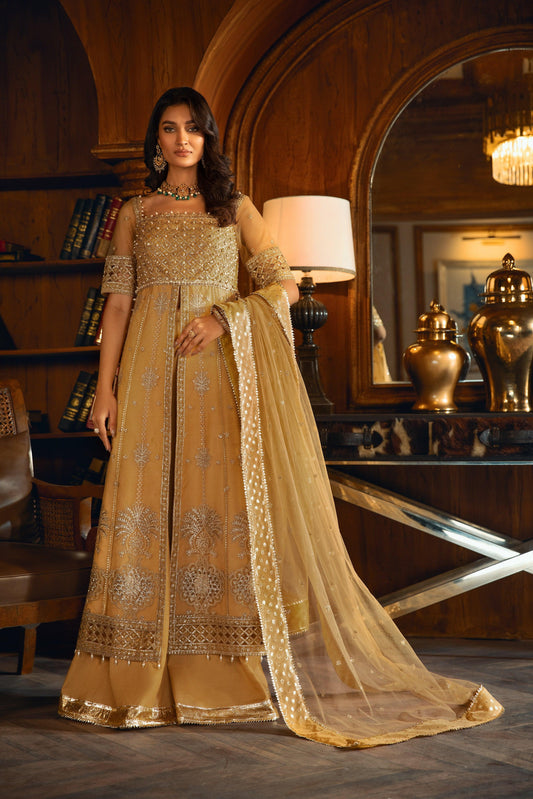 Woman in gold embellished formal dress from LA ELISE in an elegant room with classic decor