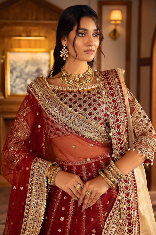 Woman in maroon and gold embellished formal dress, traditional jewelry, LA ELISE fashion