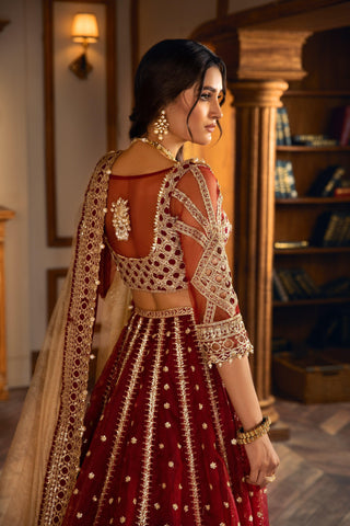 Woman in ornate maroon and gold embroidered formal dress, LA ELISE unstitched collection